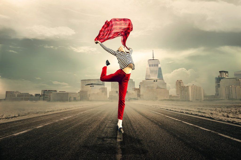 woman dancing with a red cloth on the street